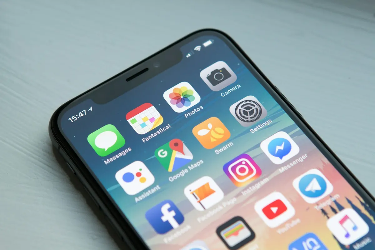 Smartphone in hand with a glowing app interface