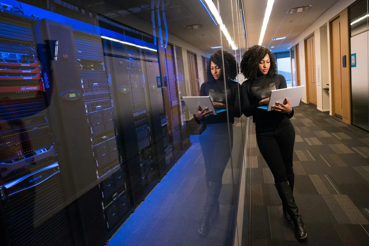 Engineer reviewing data across monitors